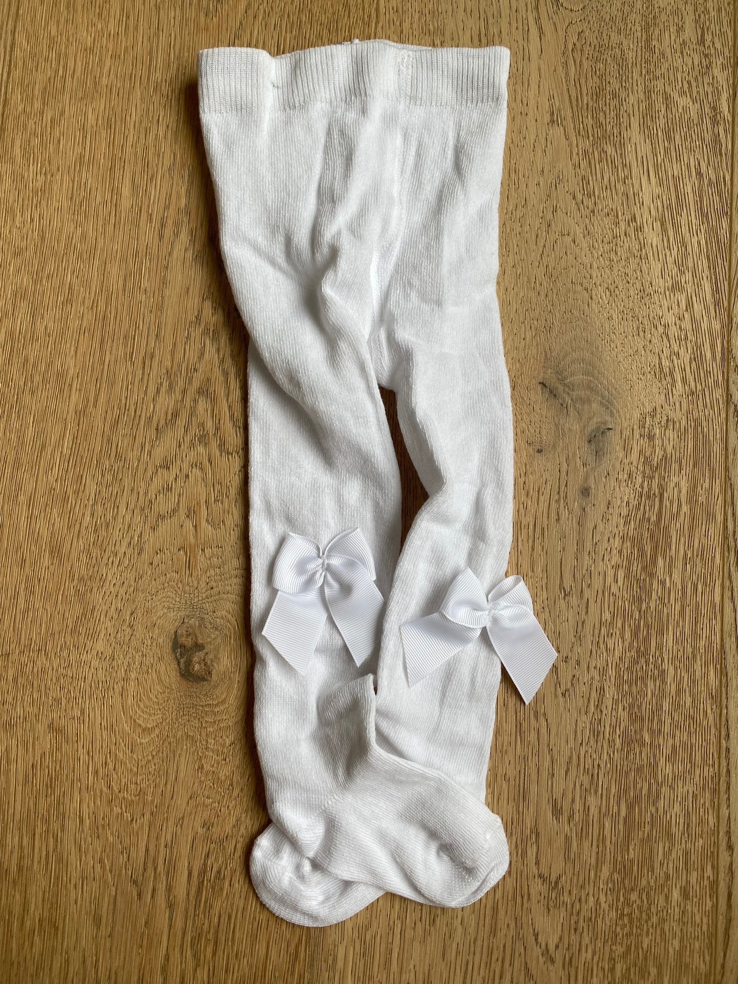 Witte kousenbroek met strik